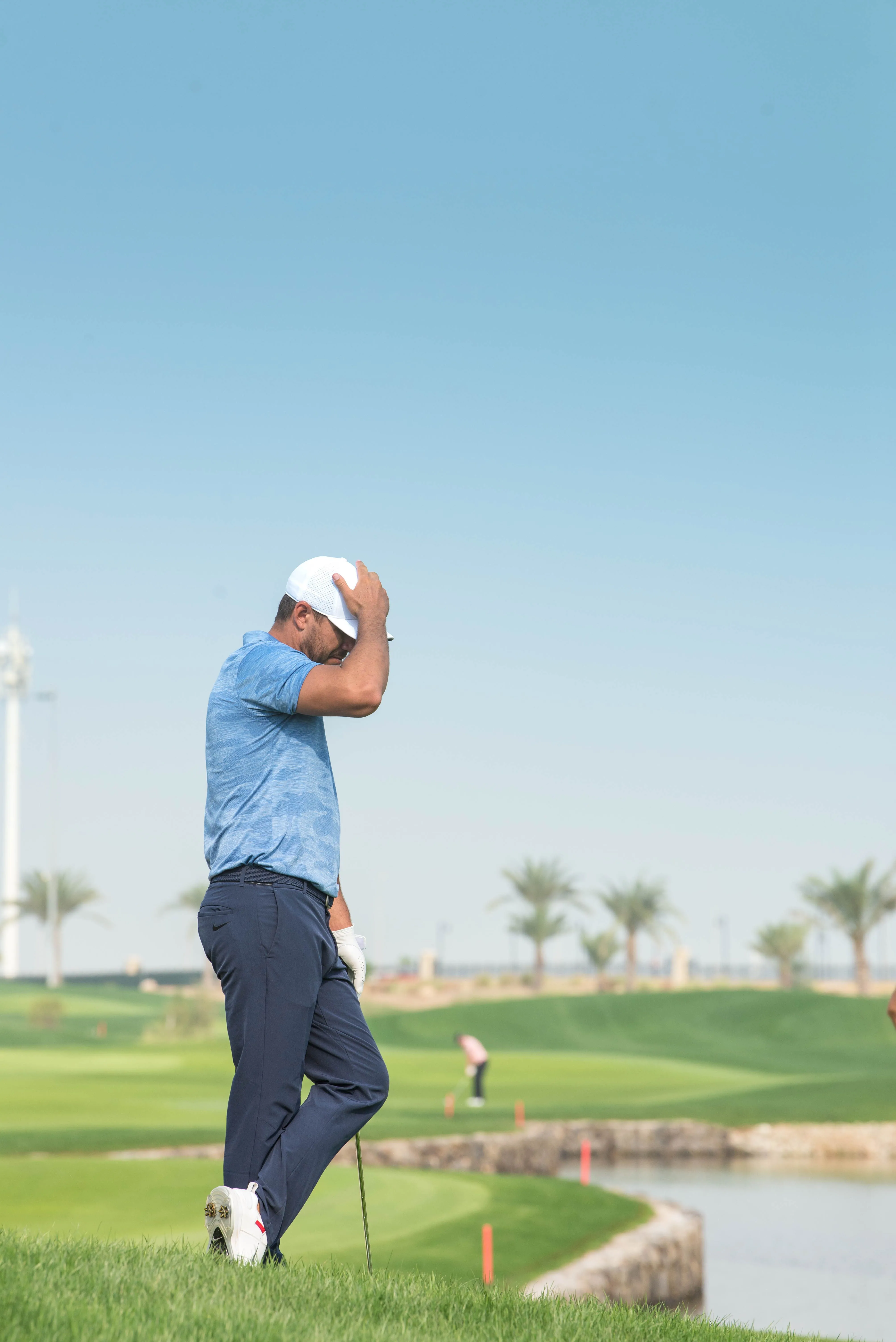 Golfer assessing a shot from thick rough