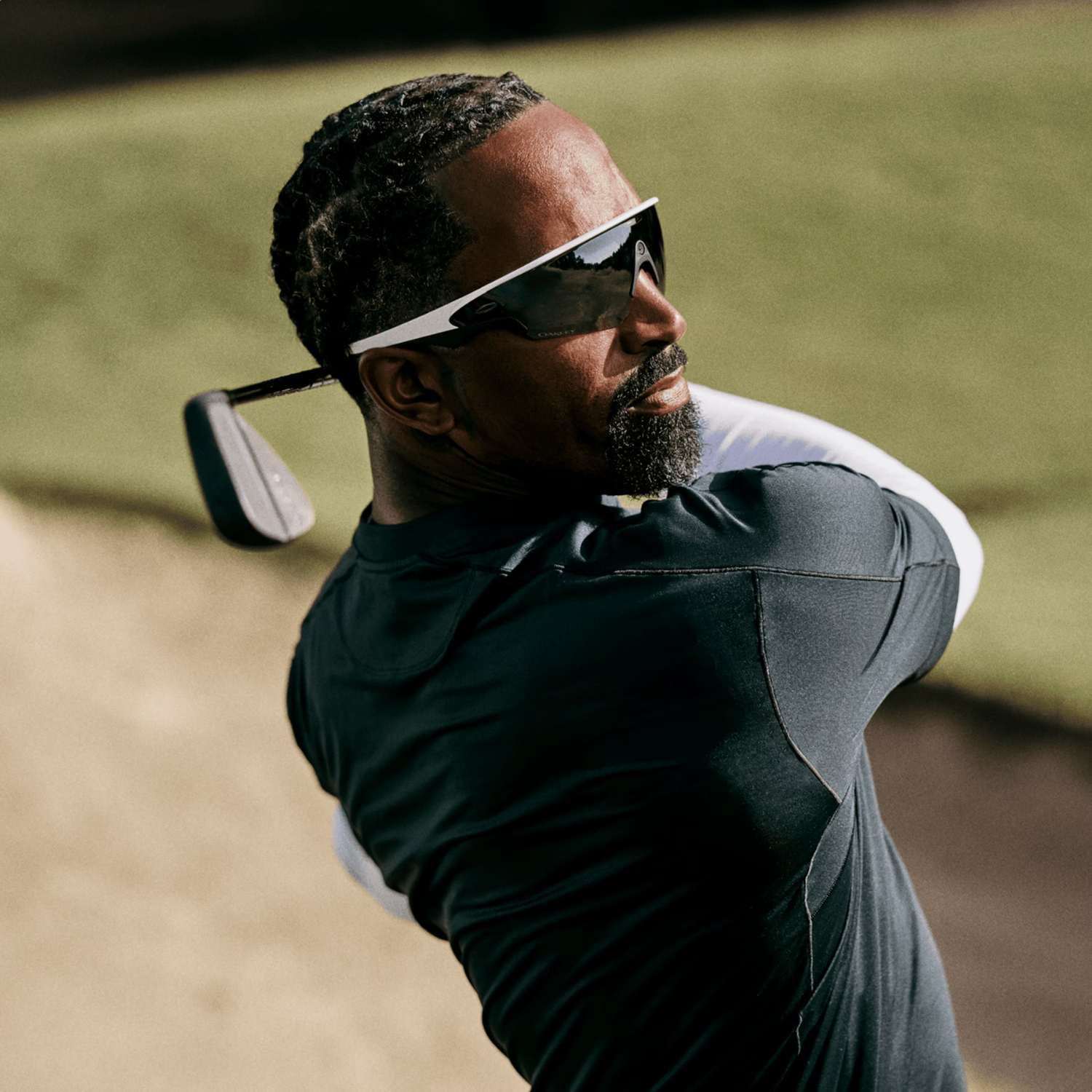 Golfer watching the result of a committed swing